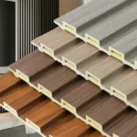 Close-up of three fluted wall panels in different wood and stone finishes, showing groove profile and hollow edge