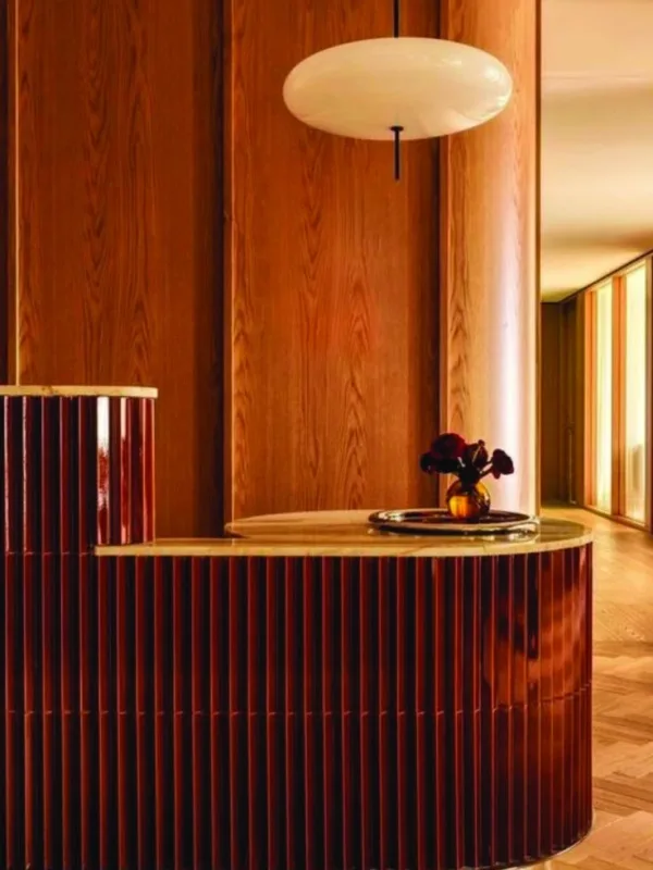Curved reception counter and wall finished with Pharaon panels