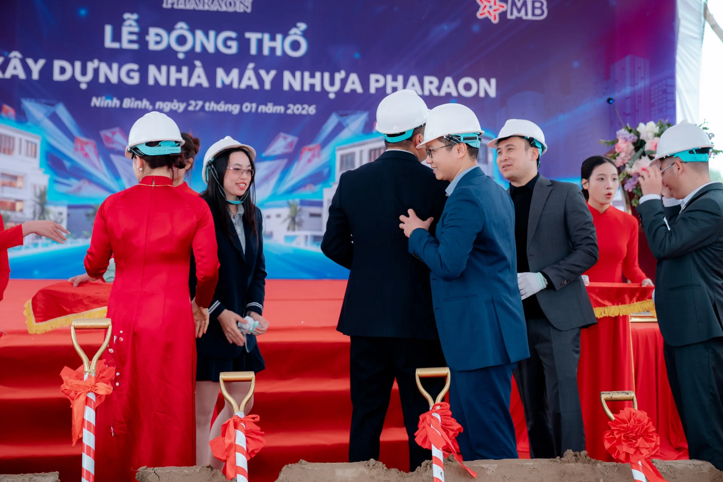 Safety helmets in front of the project backdrop dated 27 January 2026