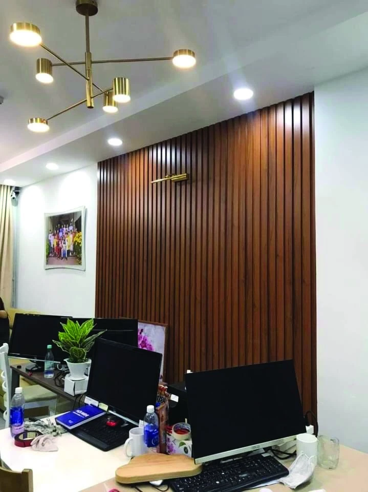 Office interior clad with PVC fluted wall panels running the full height of the wall